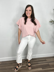 Outfit styled with the Wyatt stretchy cropped flare pants and the pink checkered short sleeve dolman top with black strap wedges.